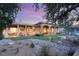 Beautiful covered patio extends living space to landscaped backyard with custom rock feature and lush greenery at 1234 Campbell Dr, Las Vegas, NV 89102