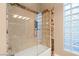Modern bathroom with glass-enclosed shower, marble accents, and unique lighting, offering a luxurious bathing experience at 1234 Campbell Dr, Las Vegas, NV 89102