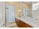 Stylish bathroom with a long countertop, modern fixtures, glass block window, and ample storage, combining functionality and design at 1234 Campbell Dr, Las Vegas, NV 89102