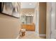 Bathroom hallway leading to double sink vanity with marble countertops and decorative lighting, providing a spa-like feel at 1234 Campbell Dr, Las Vegas, NV 89102