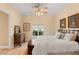 Bright bedroom features neutral walls, hardwood floors, and a comfortable bed, bathed in natural light through a window at 1234 Campbell Dr, Las Vegas, NV 89102
