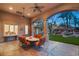 Inviting covered patio with comfortable seating, ceiling fans, and serene views of a custom rock waterfall feature at 1234 Campbell Dr, Las Vegas, NV 89102