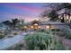 Inviting twilight shot of a home with desert landscaping and well-lit front entrance at 1234 Campbell Dr, Las Vegas, NV 89102