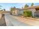 Exterior shot showcasing a long driveway leading to a well-maintained home with desert landscaping and attached garage at 1234 Campbell Dr, Las Vegas, NV 89102
