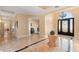 Elegant foyer with marble floors, chandelier, and grand front door showcasing luxurious home interior design at 1234 Campbell Dr, Las Vegas, NV 89102