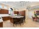 Elegant kitchen features wood cabinetry, stone countertops, stainless steel appliances, and modern lighting fixtures at 1234 Campbell Dr, Las Vegas, NV 89102
