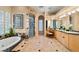 Luxurious main bathroom with soaking tub, glass shower, dual vanities, and elegant tile work at 1234 Campbell Dr, Las Vegas, NV 89102