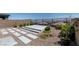 Backyard featuring desert landscaping, patio area, gravel, and a view of the neighborhood at 12524 Skylight View St, Las Vegas, NV 89138