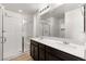 Modern bathroom with double vanity, large mirror and glass enclosed shower at 12524 Skylight View St, Las Vegas, NV 89138