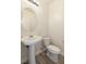 Bright powder room featuring modern fixtures, pedestal sink, and a comfort height toilet at 12524 Skylight View St, Las Vegas, NV 89138