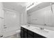 Well-lit bathroom featuring a double vanity with modern fixtures and a shower-tub combo at 12524 Skylight View St, Las Vegas, NV 89138