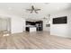 Open-concept living room and kitchen with hardwood floors and lots of natural light at 12524 Skylight View St, Las Vegas, NV 89138