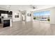 Bright open-concept living room and kitchen with luxury vinyl plank flooring and large sliding doors at 12524 Skylight View St, Las Vegas, NV 89138