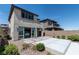 Rear exterior showcasing a patio, desert landscaping, and sliding glass doors at 12524 Skylight View St, Las Vegas, NV 89138
