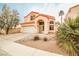 Charming two-story home featuring arched entryway, desert landscaping, and attached two-car garage at 1604 Tamborine Ct, Las Vegas, NV 89128