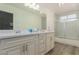 Modern bathroom featuring double vanity, large mirror, and shower with glass doors at 1900 Cameron St, Las Vegas, NV 89102
