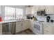 Well-lit kitchen featuring stainless steel appliances, white cabinets, and updated countertops at 1900 Cameron St, Las Vegas, NV 89102