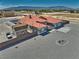 An aerial view of the property featuring a clay tile roof, a detached shed, and an enclosed back yard at 2171 Deadwood St, Pahrump, NV 89048