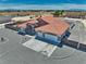 Aerial view of the property showcasing the red tile roof, three-car garage, and desert landscaping at 2171 Deadwood St, Pahrump, NV 89048