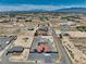 This aerial shot reveals a home with a red-tiled roof and a private pool, nestled in the vast desert landscape at 2171 Deadwood St, Pahrump, NV 89048