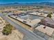 Aerial shot showing home and neighboring properties, surrounded by gravel landscaping and beautiful mountain views at 2171 Deadwood St, Pahrump, NV 89048