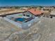 Aerial view showcases a private backyard with a pool, pergola, and well-maintained landscaping, fully fenced for seclusion at 2171 Deadwood St, Pahrump, NV 89048