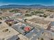 Vast aerial view of a desert home with an inviting pool and expansive yard, all set against distant mountain views at 2171 Deadwood St, Pahrump, NV 89048