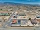 This aerial view showcases a desert home with a red tile roof and a refreshing, enclosed swimming pool at 2171 Deadwood St, Pahrump, NV 89048