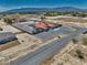 Expansive property featuring a home with red tile roof, pool, and large gravel area, backed by distant mountains at 2171 Deadwood St, Pahrump, NV 89048