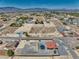 This aerial image showcases a desert home with a private pool and an expansive desert landscape at 2171 Deadwood St, Pahrump, NV 89048