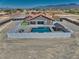 Aerial view featuring a backyard pool, pergola and landscaped area, enclosed by a clean white vinyl fence at 2171 Deadwood St, Pahrump, NV 89048