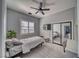Bedroom with a ceiling fan, window, mirrored closet, and wood-look flooring at 2171 Deadwood St, Pahrump, NV 89048
