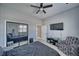 Bright bedroom featuring a ceiling fan, a closet with mirrored doors, and wood-look flooring at 2171 Deadwood St, Pahrump, NV 89048