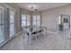 Dining room featuring gray floors, a table for six, and plantation shutters, perfect for Gathering meals or entertaining guests at 2171 Deadwood St, Pahrump, NV 89048