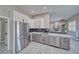 Bright kitchen with custom cabinets, stainless steel appliances, and tile flooring at 2171 Deadwood St, Pahrump, NV 89048