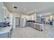 Bright kitchen with stainless steel appliances, dual ovens, custom cabinetry, and tile floors at 2171 Deadwood St, Pahrump, NV 89048