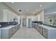 Open kitchen featuring stainless steel appliances, marble countertops, and gray and white cabinetry at 2171 Deadwood St, Pahrump, NV 89048