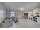 Spacious living room with ceiling fan, fireplace, large sectional, and modern tile floors at 2171 Deadwood St, Pahrump, NV 89048
