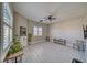 Bright living room features a ceiling fan, light gray floors, and bright windows, perfect for relaxing or entertaining at 2171 Deadwood St, Pahrump, NV 89048