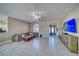 Well-lit living space with a ceiling fan, tile floors, and an inviting sectional sofa at 2171 Deadwood St, Pahrump, NV 89048