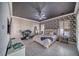 Main bedroom suite with a black accent ceiling, chic wallpaper, light floors, and plenty of space for relaxing at 2171 Deadwood St, Pahrump, NV 89048