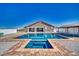 Beautiful pool featuring a hot tub, with a covered backyard patio seating area ideal for entertaining guests at 2171 Deadwood St, Pahrump, NV 89048
