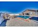 A beautiful backyard featuring a pool, spa, gazebo, and hanging swing chairs at 2171 Deadwood St, Pahrump, NV 89048