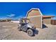 ATV parked near the house with a detached shed and a gray rock yard at 2171 Deadwood St, Pahrump, NV 89048