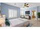 Staged bedroom features blue walls, carpet, ceiling fan, and furniture at 224 Devotion Ct, Henderson, NV 89052