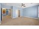 Spacious bedroom features blue walls, carpet, and multiple doorways at 224 Devotion Ct, Henderson, NV 89052