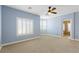 Spacious bedroom features blue walls, carpet, ceiling fan, and window shutters at 224 Devotion Ct, Henderson, NV 89052