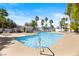 Resort-style community pool featuring palm trees, lounge chairs, and a shaded cabana area at 224 Devotion Ct, Henderson, NV 89052