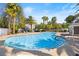 Community pool with clean water, palm trees, lounge seating, and shade areas at 224 Devotion Ct, Henderson, NV 89052