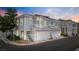 Charming townhome exterior with two-car garage and well-maintained landscaping at 224 Devotion Ct, Henderson, NV 89052